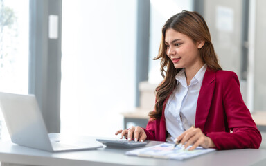 Young pretty business woman bookkeepers online consult on laptop with stock market earning and profit, tax, yearly planning, Powerful expert management complete bookkeeping service and solutions