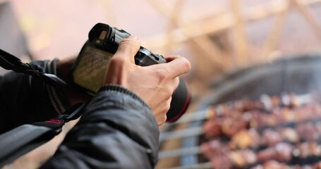 Food photographer shoots barbecue cooking on grill