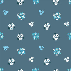 Pattern of small flowers on a gray background. Seamless vector image.