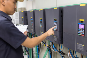 Inverter Control Room System Electrical engineers monitor the controller's frequency and current...