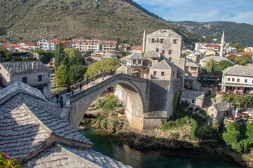 Fototapeta na wymiar Old bridge made of stone during Ottoman era, over Neretva River, in Southern part of Bosnia in city of Mostar