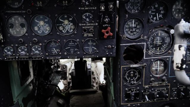 Control panel in cabin of old aircraft with command texts in russian language: latitude, altitude, stop, attention. Pilots' seats and indicators. Military aeroplane. No logo and trademarks