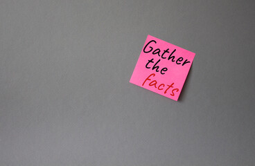 Gather the facts symbol. Concept words Gather the facts on pink steaky note. Beautiful grey background. Business and Gather the facts concept. Copy space.