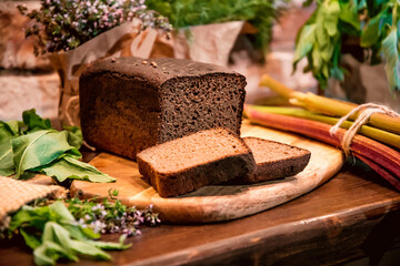 bread, radish, garlic, celery, rhubarb, thyme, mint, sorrel, dill, oregano on a board. Still life on a table of vegetables, herbs and spices. The vegetable garden 