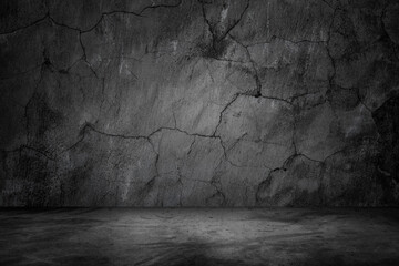 Dark room with black cracked wall , concrete floor textured background.