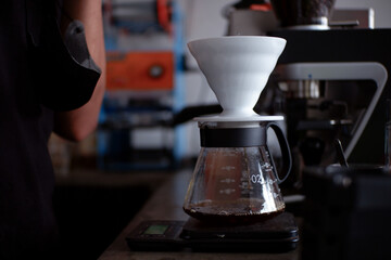 a barista who will brew coffee using the v60 method