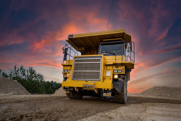 A large quarry dump truck in a coal mine. Loading coal into body work truck. Mining equipment for the transportation of minerals.