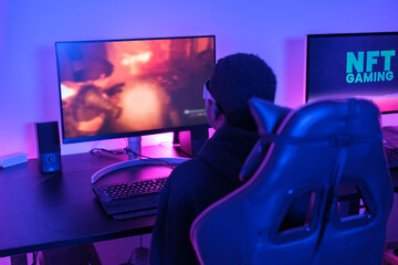 Young man playing video games from home with virtual reality glasses to make a more exciting experience. Concept: technology, games, fun