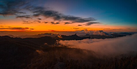 Magical sunset above the clouds with Teide volcano on the horizon. Sunset cinematic view from the top of Gran Canaria Island Pico de las Nieves point.