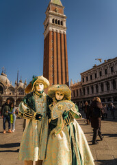 People wearing elaborate and colorful costumes and masks during the Venice 2023 carnival in Venice, Italy