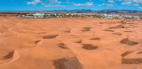 Panoramic aerial scene of the Maspalomas Dunes in Playa del Ingles, Maspalomas, Gran Canaria, Spain. Endless desert sands. Magical safari dunes.
