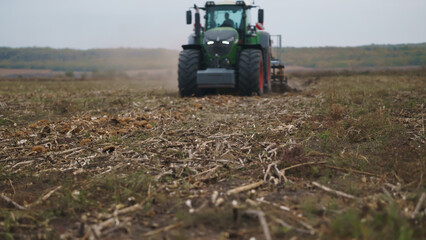 Tractor working in the field. Autumn tillage. Deep ripping with powerful tractor