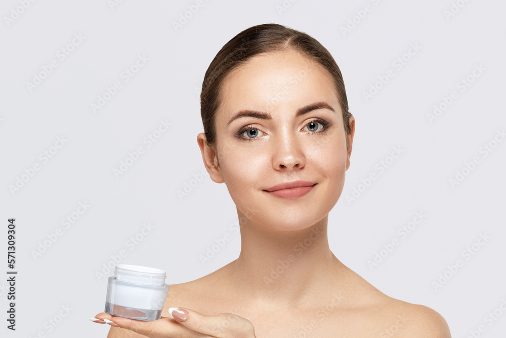 Canvas Prints beautiful young woman with clean fresh skin. girl holding cream in her hand .spa and face care