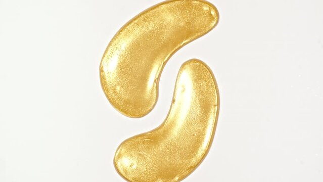 Golden patches for the eyes and facial mask for skin care Isolated on white background. Women's cosmetics skincare. Sample of packaging for design, beauty product, advertising.4k. High quality 4k 