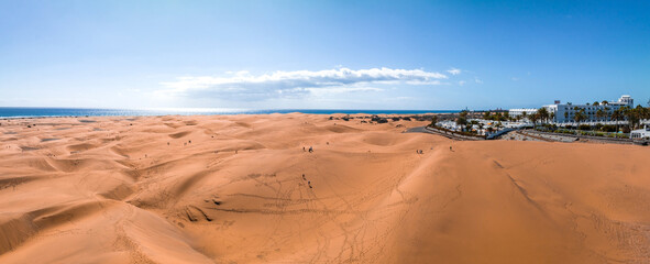 Panoramic aerial scene of the Maspalomas Dunes in Playa del Ingles, Maspalomas, Gran Canaria, Spain. Endless desert sands. Magical safari dunes.