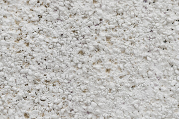 Abstract white uneven bumpy textured wall background, close up