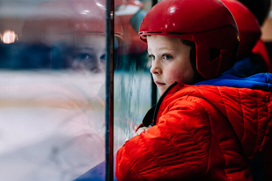 Pensive boy looking at ice rink