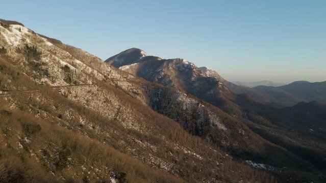 Aerial view of Mount Terminio peak with snow in wintertime, Serino, Avellino, Irpinia, Campania, Italy.
