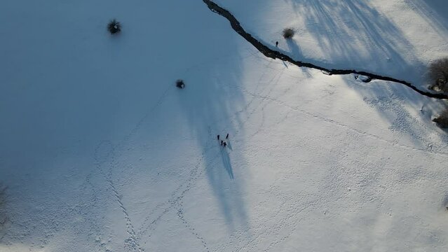 Aerial view of people on Ischia Plateau with snow in wintertime on Mount Terminio, Serino, Avellino, Irpinia, Campania, Italy.