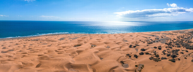 Panoramic aerial scene of the Maspalomas Dunes in Playa del Ingles, Maspalomas, Gran Canaria, Spain. Endless desert sands. Magical safari dunes.