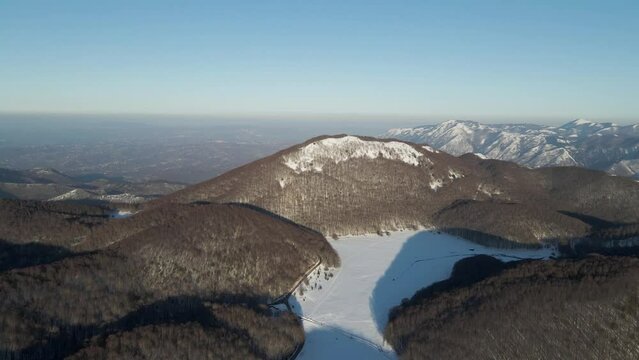 Aerial view of Verteglia Plateau with snow in wintertime at sunset on Mount Terminio, Serino, Avellino, Irpinia, Campania, Italy.