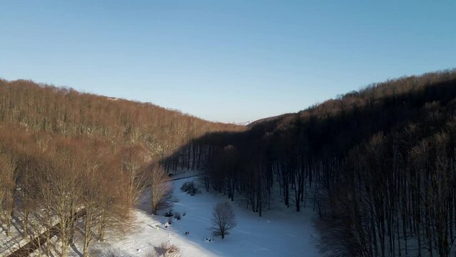 Aerial view of Verteglia Plateau with snow in wintertime at sunset on Mount Terminio, Serino, Avellino, Irpinia, Campania, Italy.
