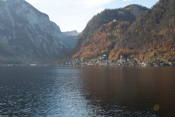hallsttat mountain village surrounded by lakes and trees in autumn