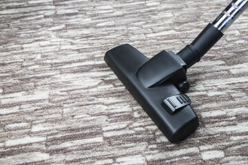 cleaning the carpet the vacuum cleaner from dirt and dust, modern household appliances for cleaning rooms, top view