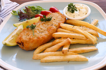 Battered grilled hake fillet and hot chips