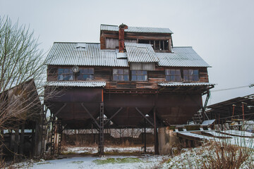 Grain elevator.Old retro grain elevator.Ancient interesting building.Old building.Unusual architecture.Ukrainian village.Grain storage place.Winter landscape.Sad mood.Old windows.Old farm.Tall barn.