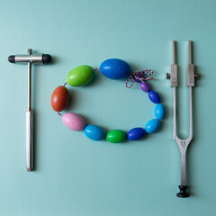 Orchidometer, neurological hammer and tuning fork lie on a blue background, medical instruments on...
