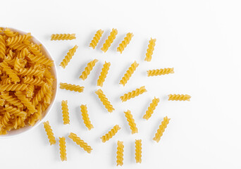 Pasta products in the form of a spiral on a plate, texture, on a white background