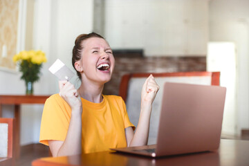 Portrait of happy excited amazed girl, shocked young successful joyful woman paying, holding credit...