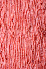 Raw beef or pork mince with salt spices and herbs on a wooden cutting board