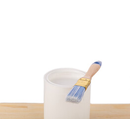 white paint with a brush on a wooden background with texture