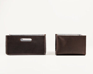 Storage baskets of brown faux leather for organizing office space