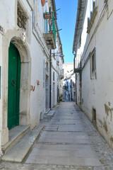 A narrow street between the old houses of Bovino, an ancient town in Puglia, Italy.