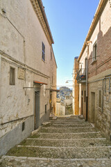 Fototapeta na wymiar A narrow street between the old houses of Bovino, an ancient town in Puglia, Italy.