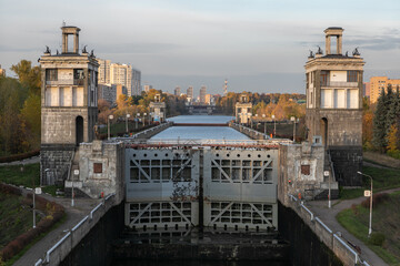 City water sluice gate on the Moscow canal with technical concrete dam buildings. Closed metal...