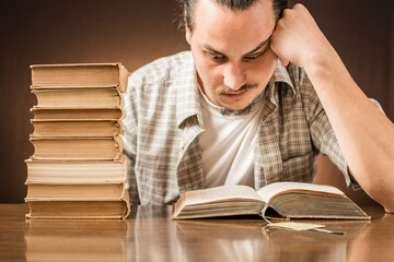 The angry student sitting on the desk with books