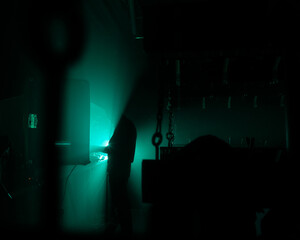 Obraz premium MOSCOW, Russia - February 2, 2023:Silhouettes in dark green lights, atmospheric shot of a nightclub