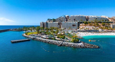 Beautiful aerial landscape with Anfi beach and resort, Gran Canaria, Spain. Luxury hotels, turquoise water, sandy beaches in Spain. Luxury beach vacation concept. Heart shaped island.