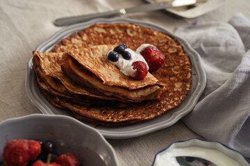 Peanut butter pancakes with fresh berries and sour cream. Low carb food ideas
