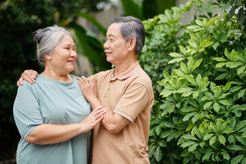 Obraz premium Happy senior couple in love standing outdoors and looking at each other