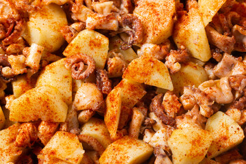 Close-up of Galician style octopus. Traditional Spanish food. Mediterranean cuisine. Pattern. Background