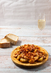 Galician style octopus duck with a glass of white sherry wine. Traditional Spanish food. Mediterranean Cuisine.