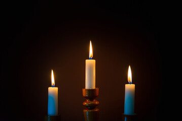 Candle flame on a dark background, symbol of prayer and remembrance.Religion concept.
