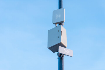 Light and wireless network on the pole with blue sky background.Telecommunications equpiment on a...