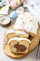 Happy Easter holiday food baking, cupcake with Easter Bunny and colorful eggs on stone background.