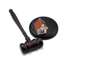Abstract photo with wooden gavel and abstract house isolated on white background